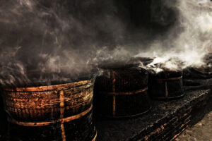 Tea leaves on bamboo baskets being baked by hot pine smoke (photo credit: François-Xavier Delmas) https://www.discoveringtea.com/2019/10/24/rare-smoked-teas/